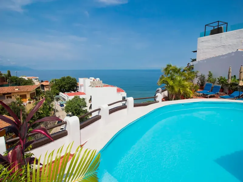 A hillside terrace with a pool above the bay